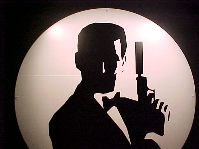 A sign with a silhouette of a man holding a gun, exuding manliness and a James Bond vibe.