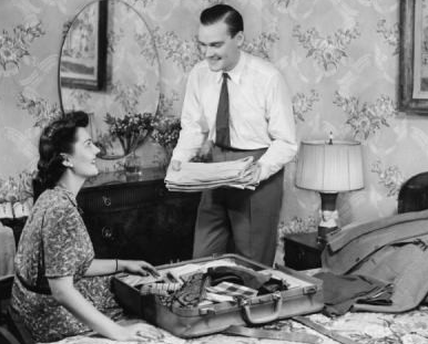 Vintage man packing suitcase with wife.