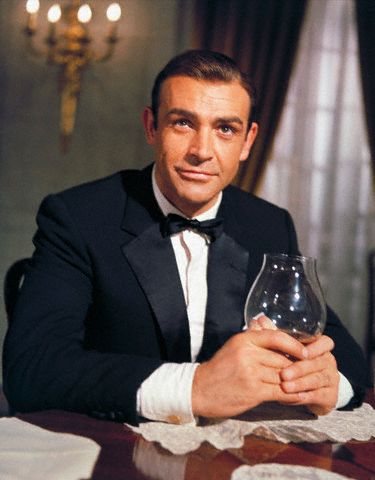 Sean Connery give posing with whiskey.