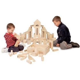 Two kids making house with wooden blocks.