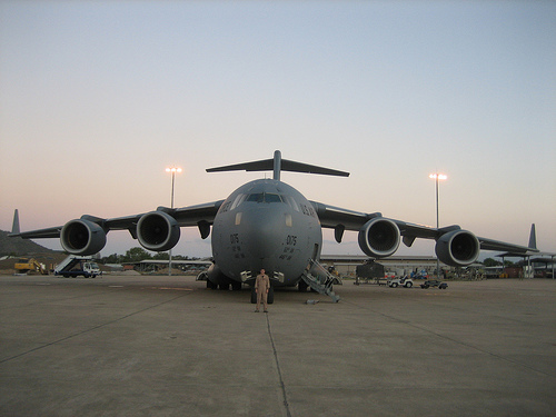 Air force pilot standing in front of galaxy aircraft.