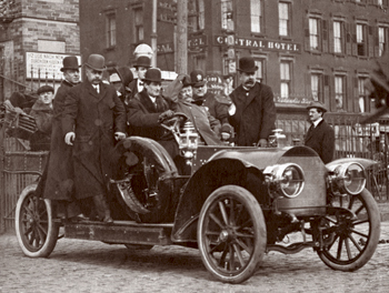 Vintage men sitting in old vehicle.