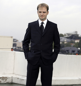 Man wearing black suit portrait.