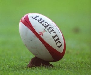 Gilbert rugby ball in ground.
