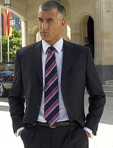 Men wearing pinstripe dark suit portrait.