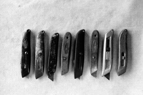 Collection of utility knives with razor blades.