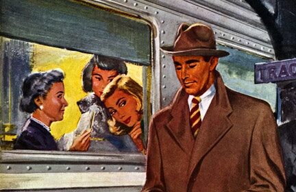 A man in a hat and coat is standing next to a train, looking like a million bucks.