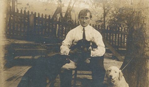 An old photograph capturing a man and his canine companions, highlighting the special bond between a man and his best friend.