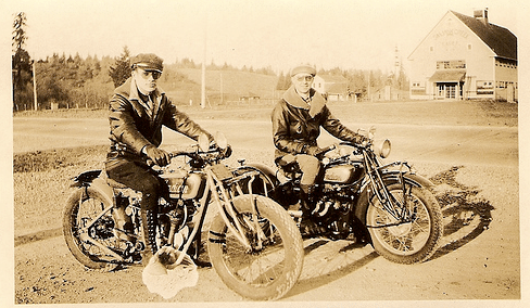 Vintage men sitting on motorcycles.