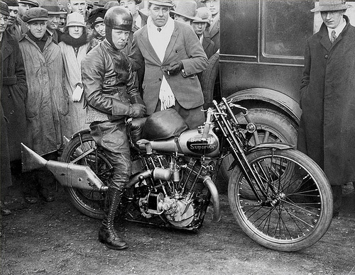 Vintage man sitting on motorcycle around the crowd portrait.