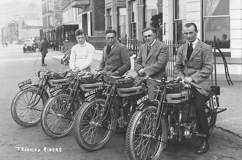 Vintage men sitting on motorcycles in the parking.