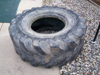 Tractor tire lying on floor.