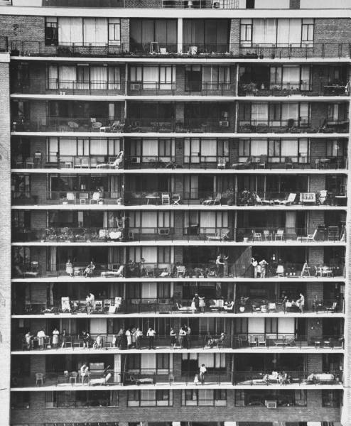 Find your first apartment with this black and white photo of an apartment building with balconies.