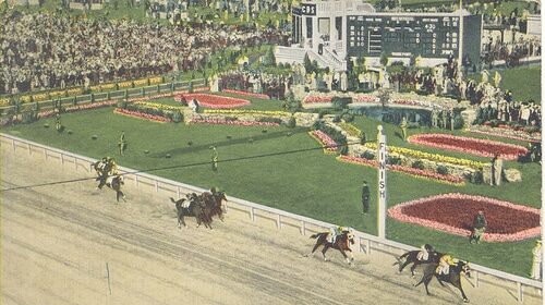 A picture of a horse race at the Kentucky Derby with people dressing up and watching.