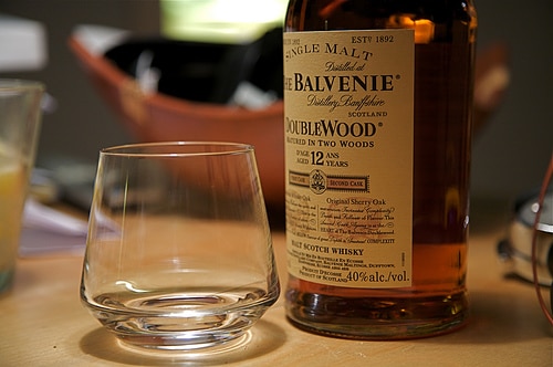 Balvenie scotch whisky with empty glass.