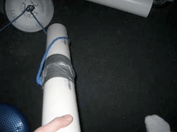 Man holding pvc pipe with duct tape gripping.