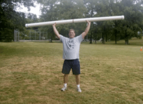 Man holding slosh pipe for fitness routine.