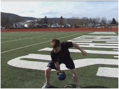 Man doing kettlebell exercise in the ground.