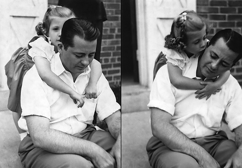 Vintage little daughter hugging and kissing her father.