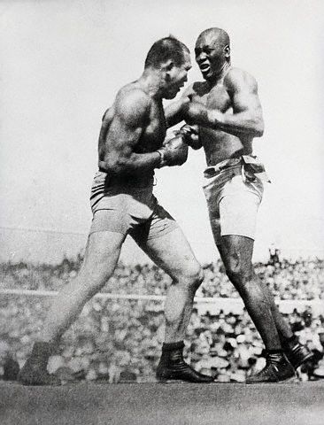 Vintage Jack Johnson fighting with J Jeffries in boxing match.