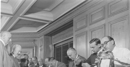 A group of men making the perfect martini.