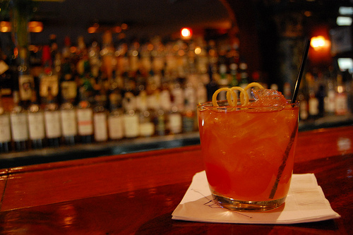 Old fashioned cocktail in lowball glass in the bar.