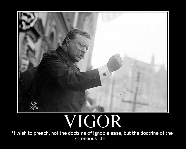 A man in a suit is holding a sign that says vigor, inspired by Theodore Roosevelt.