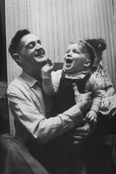 Vintage father playing with toddler son.