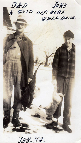 Vintage father son in hunting pose with catch.