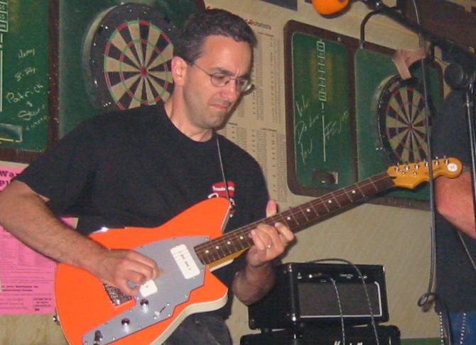 Dan Skidmore professional guitarist playing electric guitar in a show.