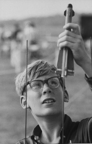 Vintage boy launching model rocket.