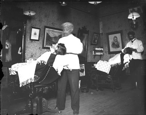 Vintage barbershop men getting shave.