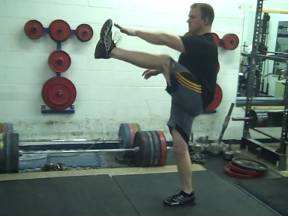 A man rising his leg while exercising.