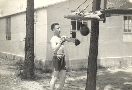 Vintage boxer practicing the speed ball bag.