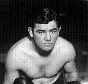       Description: A black and white photo of James J. Braddock, a man in boxing gloves.