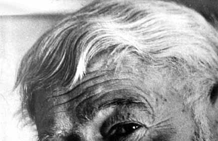 A black and white photo of Hemingway with a beard.