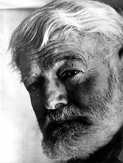 A black and white photo of Hemingway with a beard.