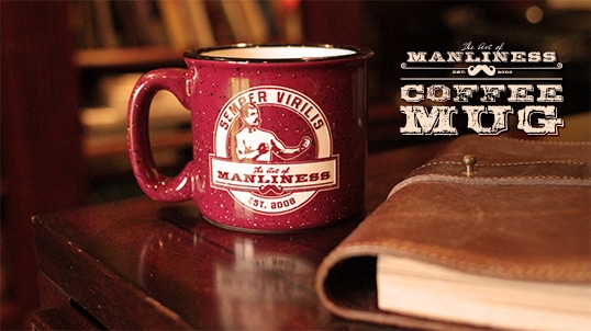 Maroon coffee mug along with a diary.