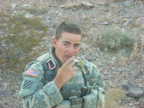 An Army Scout smoking a cigarette in the desert.