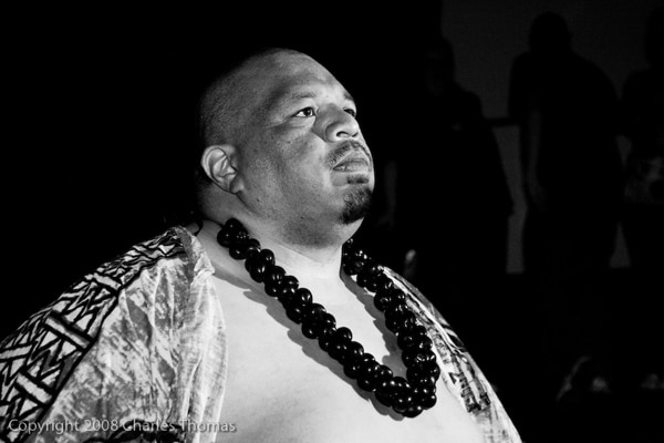 A black and white photo of a professional wrestler in a Hawaiian outfit.
