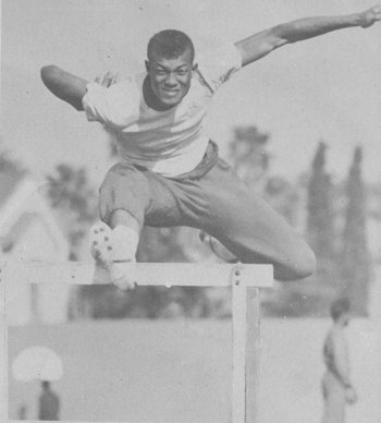 African man jumping over hurdles.