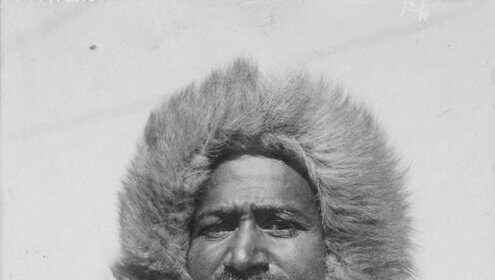 A vintage photograph capturing the manliness of Matthew Henson in a luxurious fur coat.