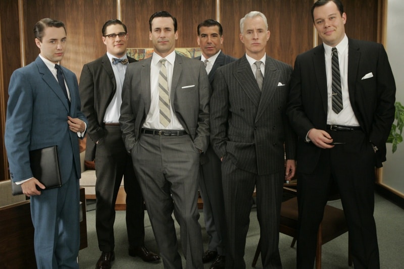 A group of Mad Men in suits posing for a picture, showcasing their manly haircuts.