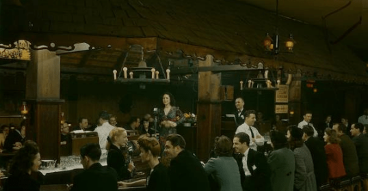 A group of people drinking at a bar.