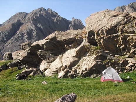Basic primer tent under cliffs while mountain climbing.