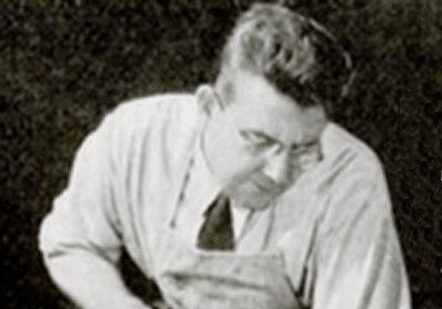An old photo of a man demonstrating exquisite toolmanship with a handsaw.