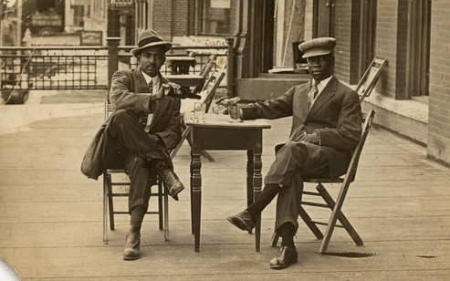 Vintage portrait of african formal men while sitting.