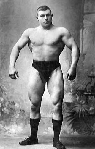 Vintage George Hackenschmidt giving pose and showing body muscles.