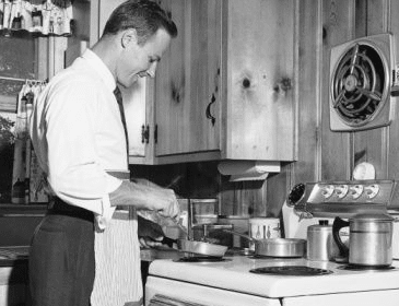 A man in an apron is preparing food in a kitchen, aiming to Impress a Date with 3 Great Meals.