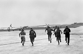 Airmen running towards planes.